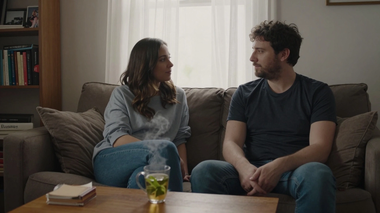 Two people sitting calmly in a modest living room, sharing a quiet moment over tea.
